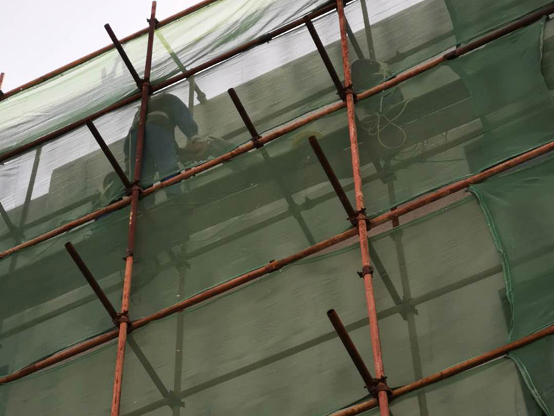 高空外墻防水：首先清理基層，新舊面層必須清理干凈，不得有雜物和灰塵，以免影響粘結(jié)強度，涂刷防水涂料時基層應干燥。接下來，清理死角，也就是所謂的陰陽角、施工縫、伸縮縫等比較重要的部位進行處理，尤其注意的是泄水孔要加強處理，需要涂刷2-3遍防水底層涂料。備好防水卷材、防水涂料、基層涂料和粘接卷材的涂料必須要分清，為提高防水卷材與基層粘結(jié)性，可用底層涂料反復涂刷，涂刷均勻，覆蓋完全，充分滲入混凝土基層，以提高粘結(jié)強度和抗剪切強度。涂刷第二次涂料之前必須要等第一次涂料完全凝固后方可再次涂刷，底層涂料第一次涂刷完畢后約4-8小時左右，方可再次涂刷第二次和第三次底層涂料。