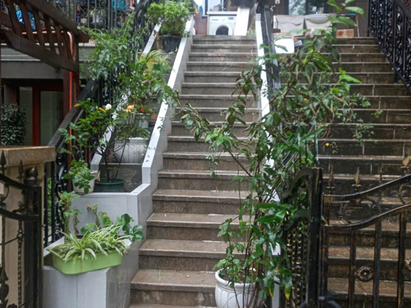 戶外樓梯加花壇：用測量儀器把花壇群中主花壇中心點(diǎn)坐標(biāo)測量到地面上，再把縱橫中軸線上的其他中心點(diǎn)的坐標(biāo)測設(shè)下來，將各中心點(diǎn)連線，即在地面上放出花壇群的縱橫軸線。放線完成后，應(yīng)沿著已有的花壇邊線開挖邊緣石基槽?；鄣拈_挖寬度應(yīng)比邊緣石基礎(chǔ)寬10厘米左右，深度可在12～20厘米之間。槽底土面要整平、夯實(shí)，有松軟處要進(jìn)行加固，不得留下不均勻沉降的隱患。在砌基礎(chǔ)之前，槽底還應(yīng)做一個(gè)3～5厘米厚的粗砂墊層，用于基礎(chǔ)施工找平。