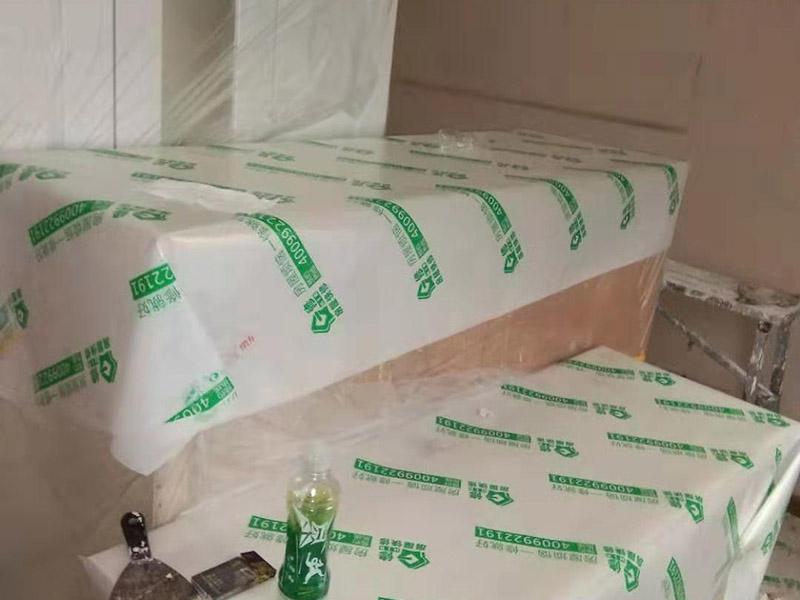 全屋家具成品保護(hù)：滿鋪成品瓦楞紙板，再用干凈彩條布滿鋪在普通石膏板上，在彩條布交接處及轉(zhuǎn)角處用膠帶固定，也可選用木芯板或三夾板。材料選用視上人、車情況而定。 所有成品飾面板在安裝好后必須用PE保護(hù)膜覆蓋包起來(lái)，所有成品飾面板的陽(yáng)角位必須用硬質(zhì)紙護(hù)角或泡沫棉進(jìn)行保護(hù)性包裝，防止交被其他施工人員碰撞。 1、入戶門扇用公司統(tǒng)一的門貼進(jìn)行全面包裹保護(hù)，用透明膠帶將保護(hù)膜粘貼牢固平整。 2、用標(biāo)準(zhǔn)保護(hù)膜將門框三面保護(hù)完整并固定牢固。 3、工程完工后拆除保護(hù)膜時(shí)如果有粘貼時(shí)的膠痕，應(yīng)用酒精或?qū)Ｓ玫那逦蹌┣宄z痕。