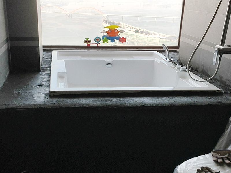 浴缸貼磚安裝：在安放浴缸時注意下水口的另一端要略高于下水口的一端，以便將來排污不暢。這一點要因情況而定。一般正常的浴缸底部本來就留出了排水的坡度。在安放浴缸時注意下水口的另一端要略高于下水口的一端，以便將來排污不暢。這一點要因情況而定。一般正常的浴缸底部本來就留出了排水的坡度。浴缸裙的貼磚是不需要抓毛的，砌好紅磚的臺子，在表面抹一層水泥砂漿，然后等兩天再來貼磚即可，貼磚很麻煩，由于地面留了坡度，而浴缸是平的，所以每一塊大磚都要打磨成不同的尺寸，不可以一次打磨很多，容易磨多了，要反復(fù)磨。磚的上邊要塞入浴缸的圓邊下，這樣才不會形成陽角。